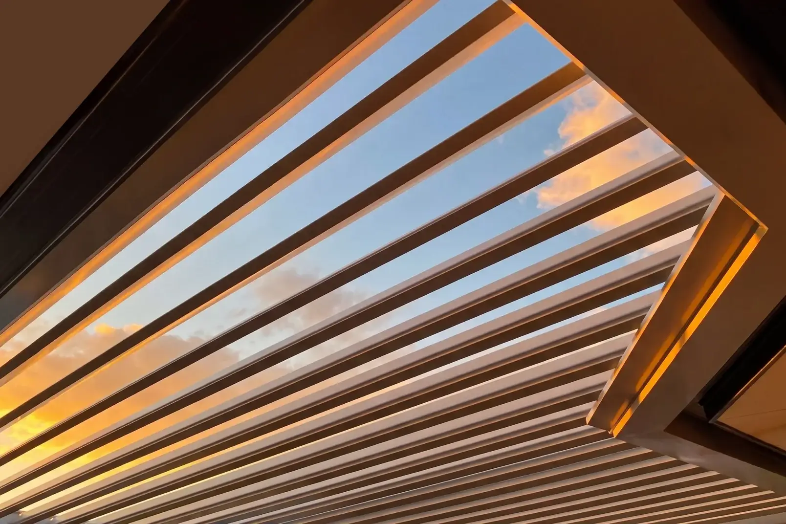 Individually engineered EXO louvre roof blades open to a sunset sky